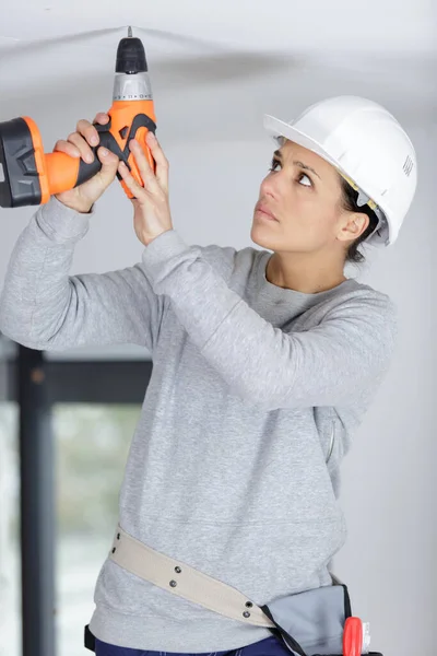 Female Worker Helmet Drilling Ceiling — Stock Photo, Image