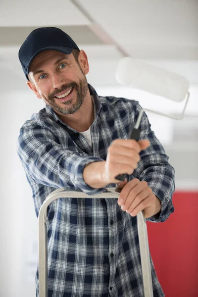 Happy Guy Stands Ladder Holding Roller — Stockfoto