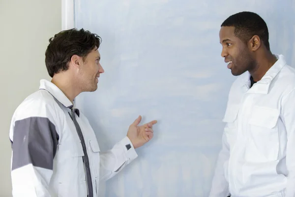 Painter Apprentice Showing Painted Wall — Stockfoto