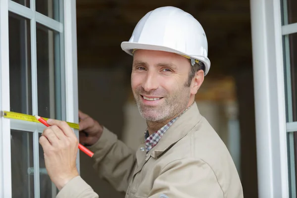 Happy Male Worker Measuring Window — Stock Photo, Image