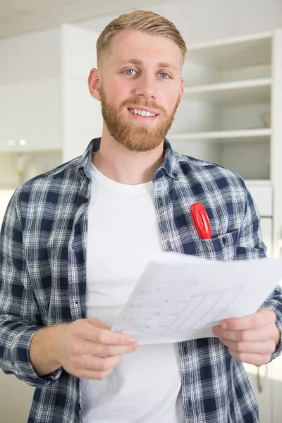 Close Male Employee Checking Plan — Photo