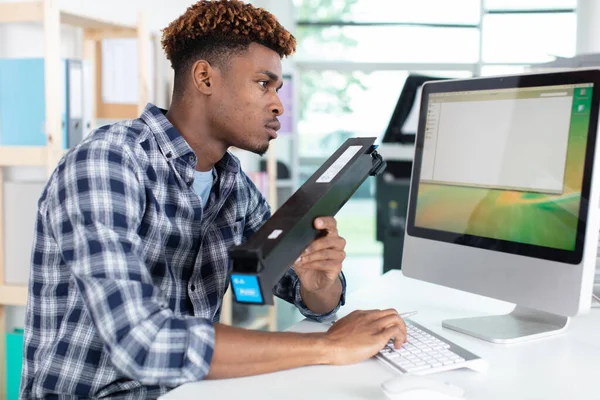 Technician Researching Toner Cartridge His Computer —  Fotos de Stock