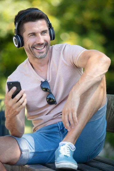 Smiling Man Sitting Bench Park Listening Music — Photo