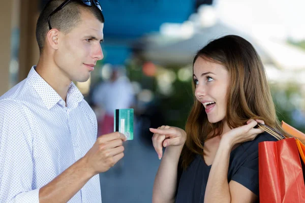 Couple Out Shopping Woman Asking Man Credit Card — Φωτογραφία Αρχείου
