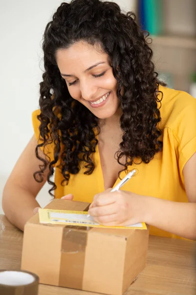 Mujer Escribiendo Etiqueta Para Enviar Paquete —  Fotos de Stock