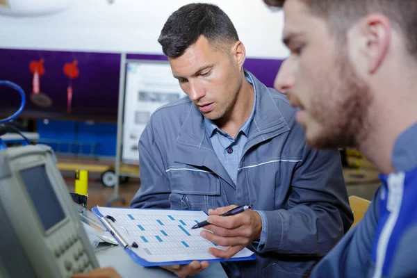 Worker Holding Clipboard While Talking His Colleague — Foto Stock