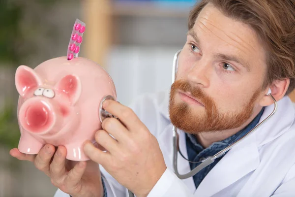 Doctor Holding Stethoscope Piggybank Continaing Blister Tablets — Fotografia de Stock