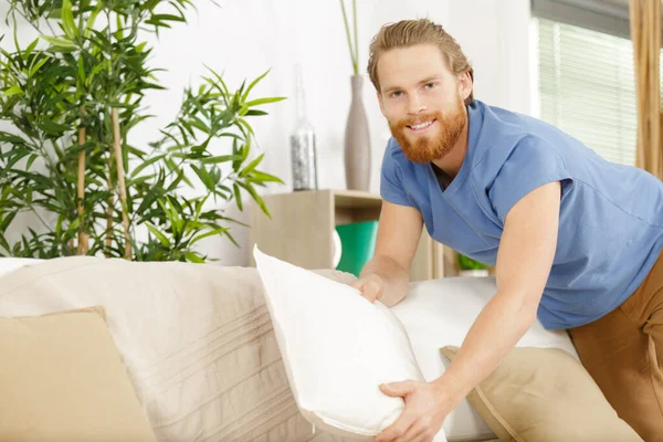 Dry Cleaning Worker Fixing Sofa Indoors — Stockfoto