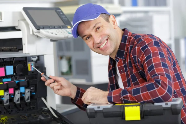 Happy Man Smiling Camera While Fixing Printer — ストック写真