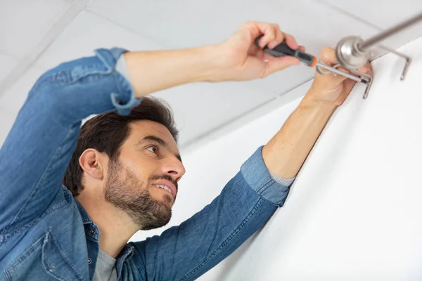 Man Fixing Bracket Curtain Rail — Stock Fotó