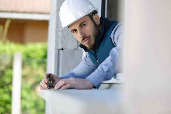 Male Contractor Using Tape Measure Window Sill — Fotografia de Stock