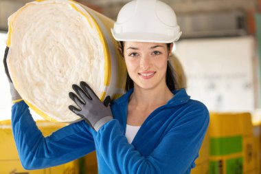 female construction worker with roll of insulating material clipart