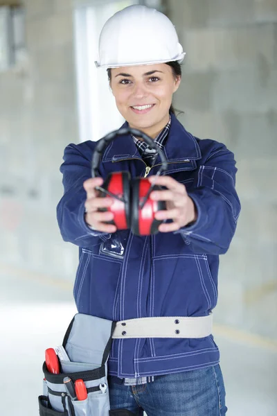 woman contractor worker with noise cancelling earmuffs