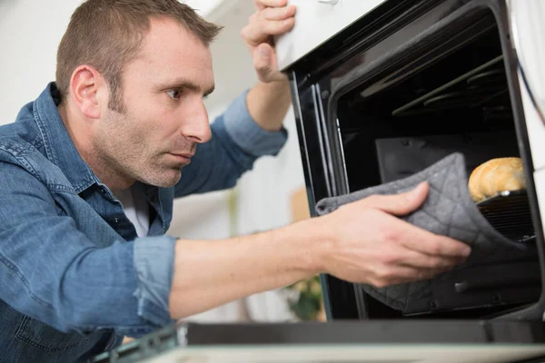 Man Taking Out Tray Baked Croissants Oven — Stock Photo, Image