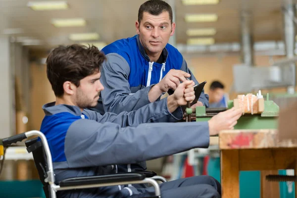与老板一起在轮椅车间工作的残疾工人 — 图库照片