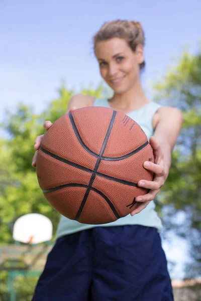 Pretty Young Blonde Woman Offering Ball — Stock Photo, Image