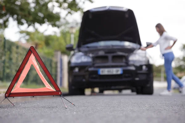 Woman Placing Emergency Warning Triangle Sign — Stock Photo, Image
