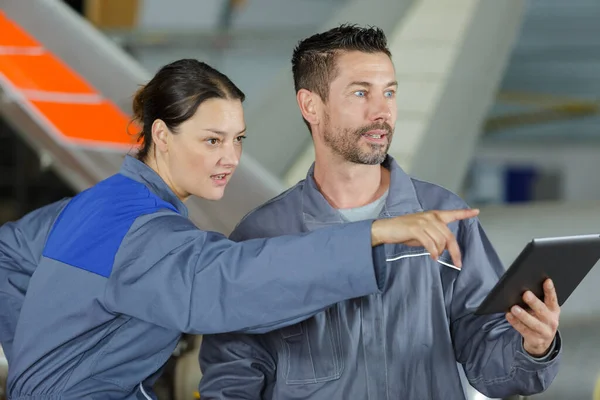 Twee Vrolijke Technici Overall Wijzen Naar Iets — Stockfoto