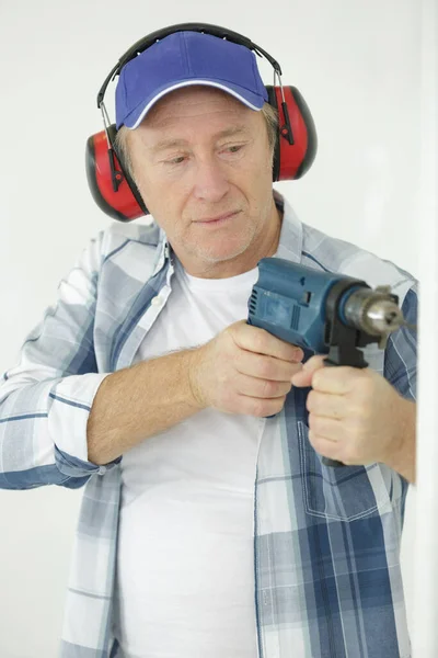 Mature Worker Drill Ear Plugs — Stock Photo, Image