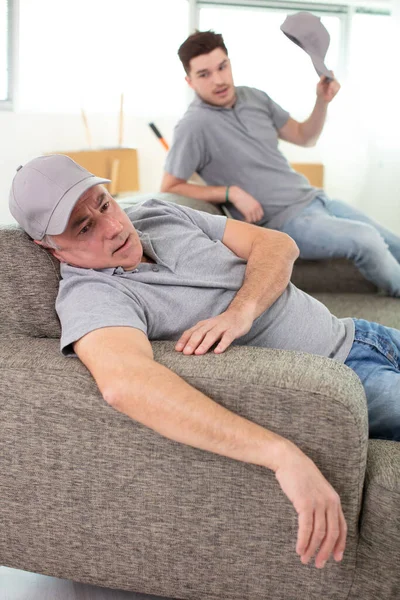 Exhausted Movers Relaxing Sofa — Stock Photo, Image