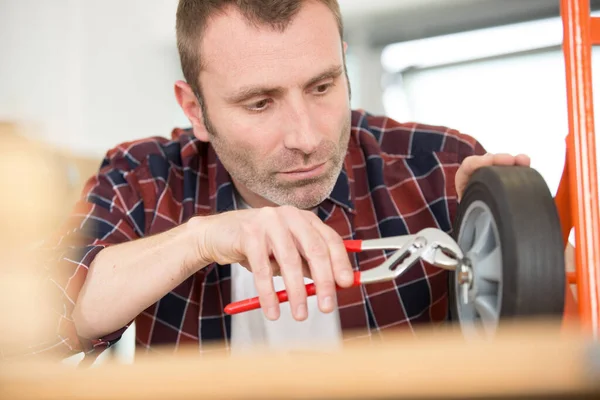 Man Med Hjälp Nyckel För Att Fixa Vagnshjul — Stockfoto