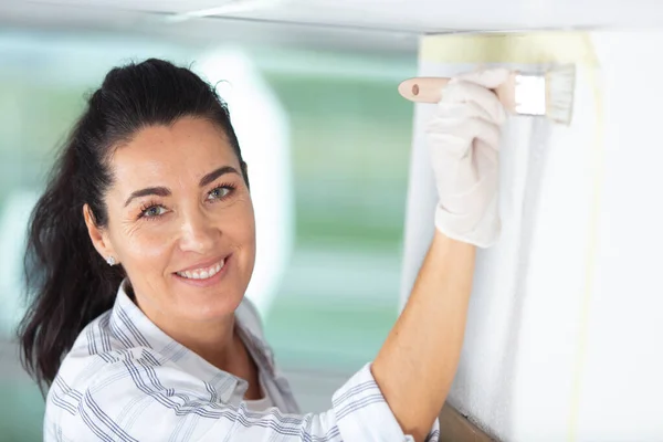 Glücklich Lächelnde Ältere Frau Bemalt Innenwand Des Neuen Hauses — Stockfoto