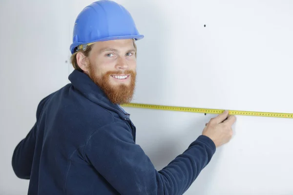 Man Measuring Wall Using Ruler — Stock Photo, Image