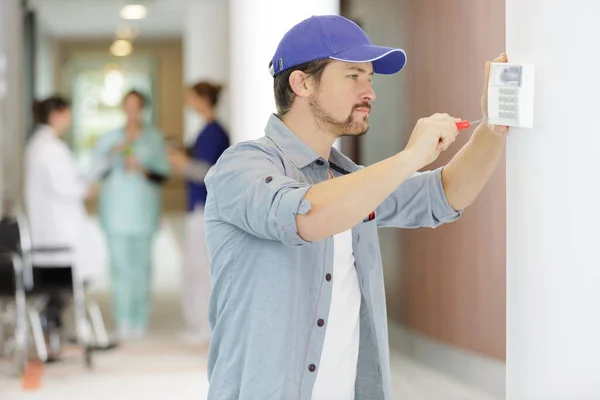 Contractor Fixing Keypad Wall Hospital — Stock Photo, Image