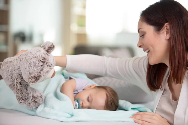 Jovem Mulher Brincando Com Urso Lado Bebê Adormecido — Fotografia de Stock