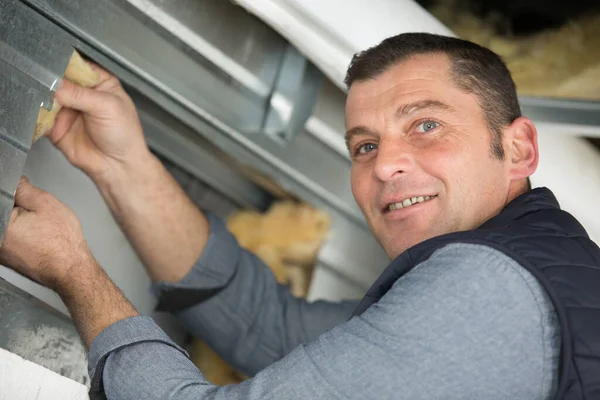 Man Inserting Insulation Metal Framework — Stock Photo, Image