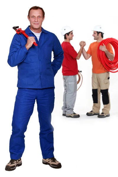 Three plumbers — Stock Photo, Image