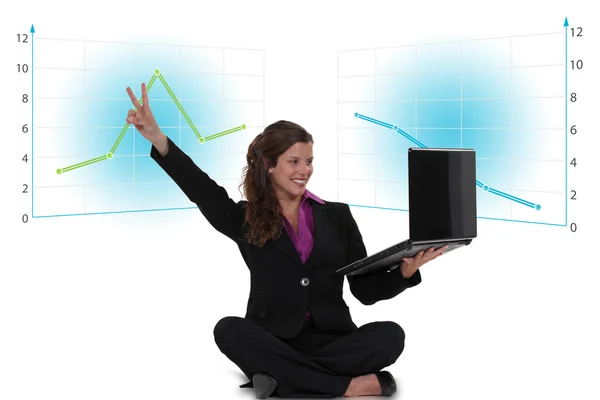 Victorious businesswoman with a laptop — Stock Photo, Image