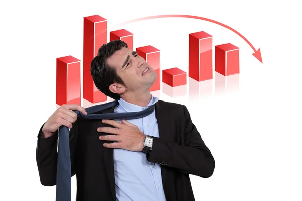 Stressed businessman with a downturn graph — Stock Photo, Image