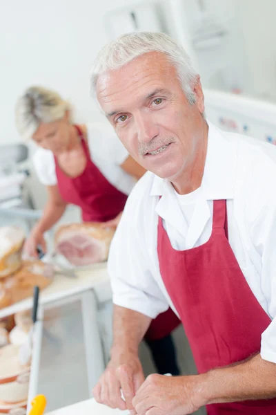 Butcher serving a female customer — Stock Photo, Image