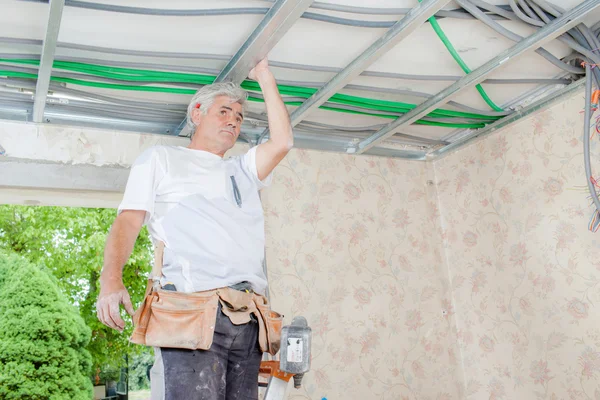 Mason drilling into a ceiling — Stock Photo, Image