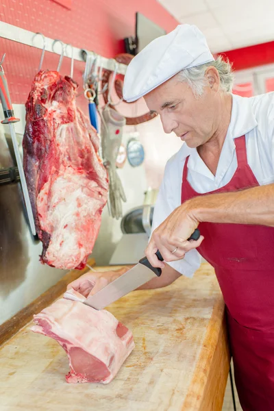 Carefully preparing a cut of beef — Stock Photo, Image