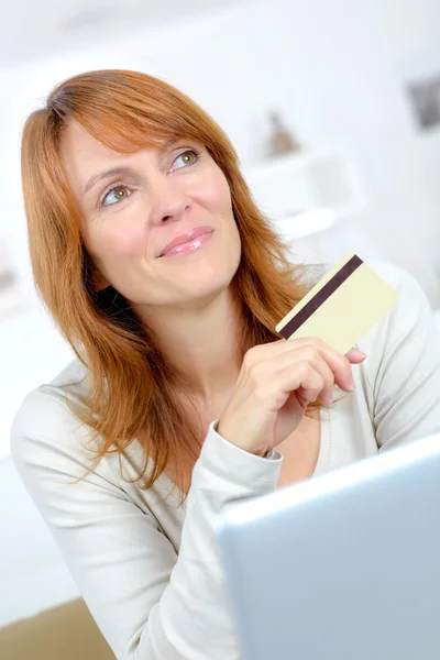 Woman thinking about shopping on-line — Stock Photo, Image