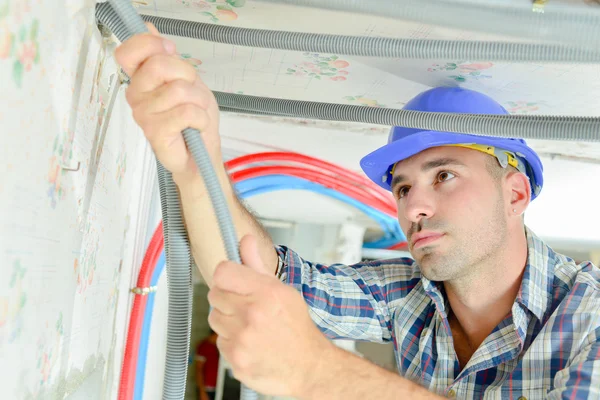 Electrician wiring a new building — Stock Photo, Image