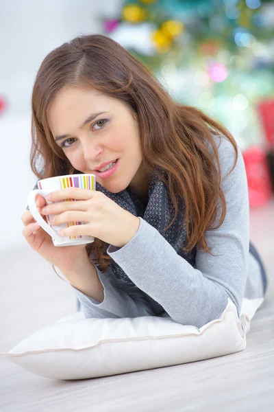 Mujer tendida en el suelo con una taza de café — Foto de Stock