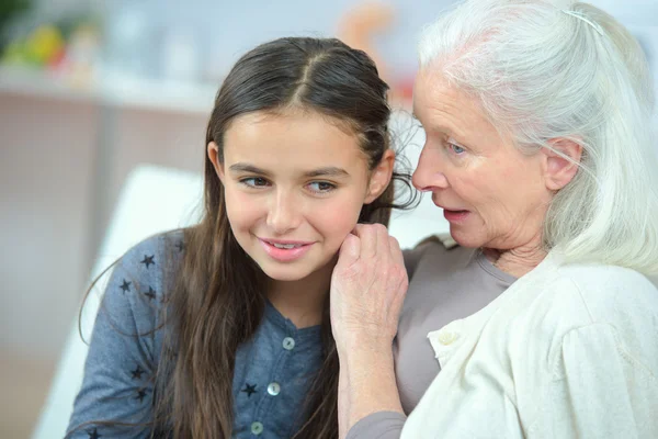 Little girl and grandma whispering secrets — Stock Photo, Image