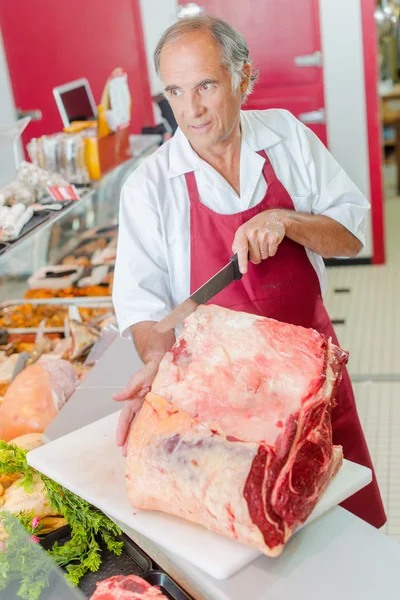 Açougueiro preparando um corte de carne bovina — Fotografia de Stock