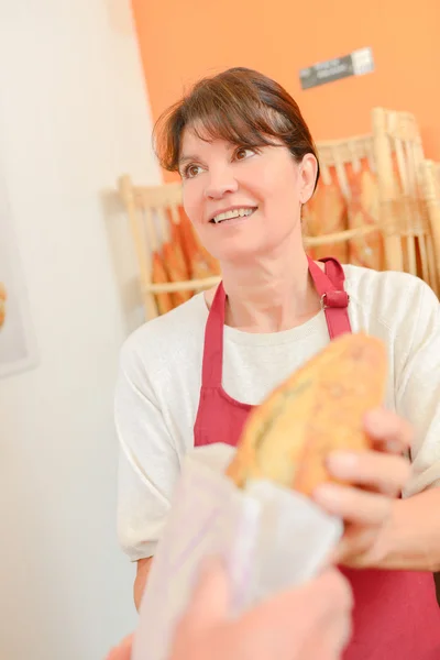 Lady serving bread — Stock Photo, Image