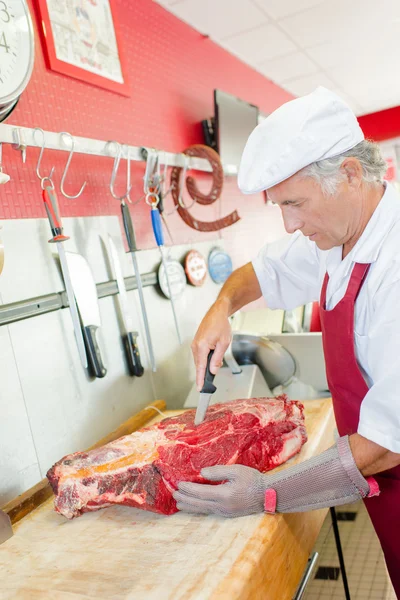 Carefully preparing a cut of beef — Stock Photo, Image