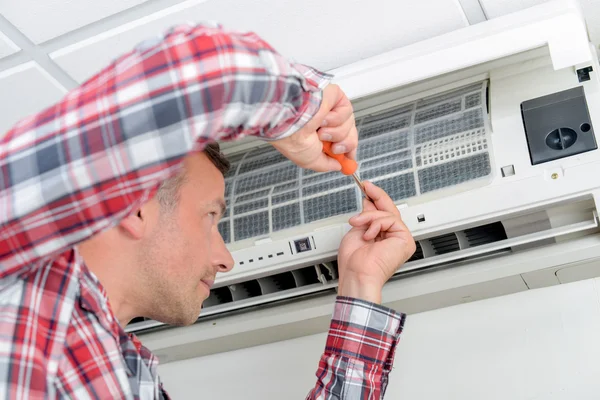 Man aan het werk op de airconditioning-installatie — Stockfoto