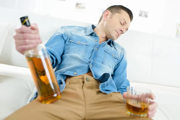 Drunk man on a sofa — Stock Photo, Image