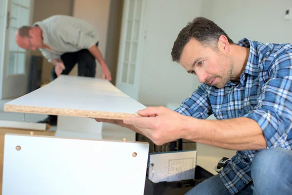 Putting together flap pack furniture — Stock Photo, Image