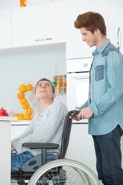 Teenager in wheelchair and his friend — Stock Photo, Image