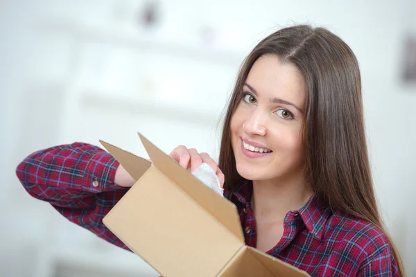 Mujer empacando cosas en una caja de cartón — Foto de Stock