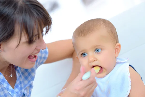 Feeding her baby boy — Stock Photo, Image