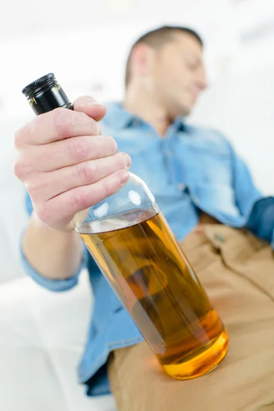 Drunk man on a sofa — Stock Photo, Image